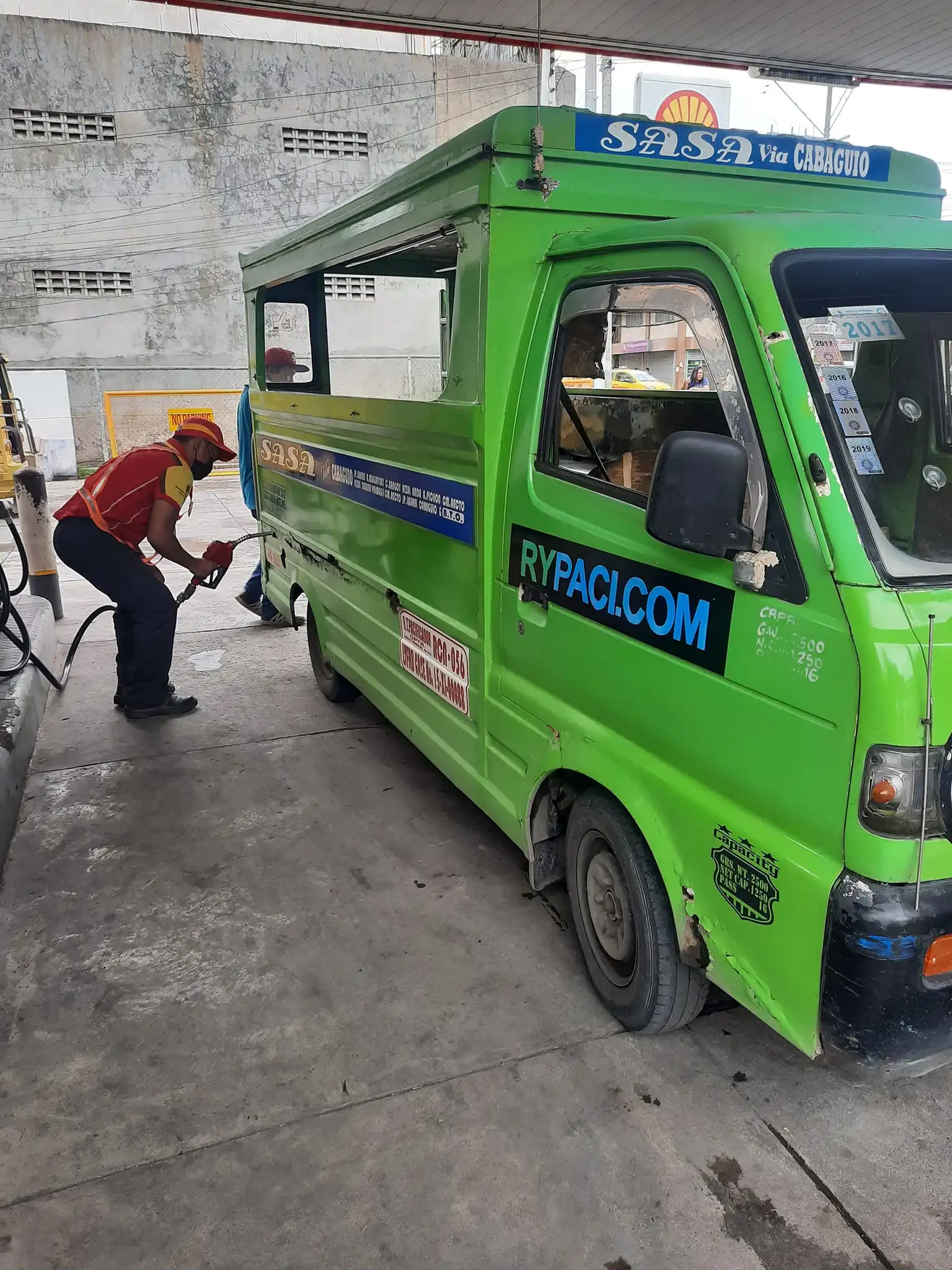a man refilling a fuel of a puj made from rypaci it solutions company