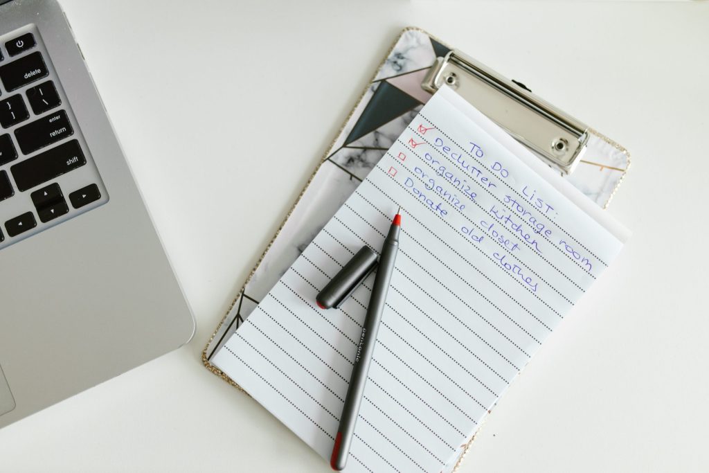 checklist notebook next to laptop for website audit